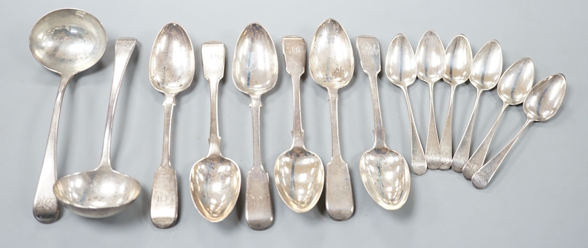 A set of six Victorian silver fiddle pattern dessert spoons, William Eaton, London, 1843, a set of six earlier silver teaspoons and a pair of George III silver sauce ladles, 14oz.